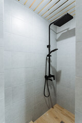 Discover a modern minimalist shower design with sleek black fixtures, integrated into a luxurious bathroom that exudes elegance and comfort, promoting relaxation and peace of mind