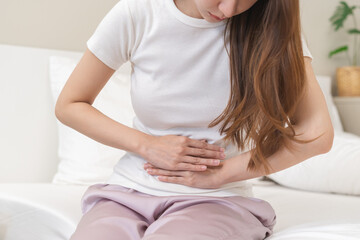 Flatulence ulcer, asian young woman, girl hands in belly, stomach pain from food poisoning, abdominal pain and digestive problem, gastritis or diarrhoea. Abdomen inflammation, menstrual period people.