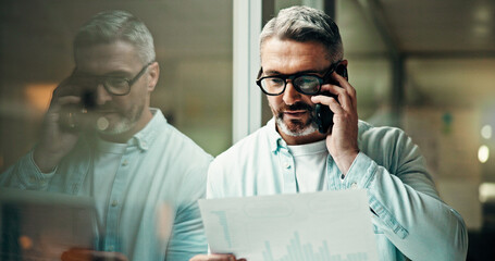 Businessman, night and discussion with phone call, documents or report for office statistics. Mature man, employee or analyst with graph, mobile smartphone or company analytics for performance review