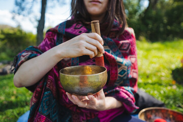 Experience the calming effects of sound healing with a singing bowl in nature, promoting...