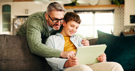 Tablet, smile and help with father and son on sofa for learning app, education game and bonding....