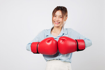 Boxing pose of a confident Asian young woman ready to fight with strength. Smile shows business...