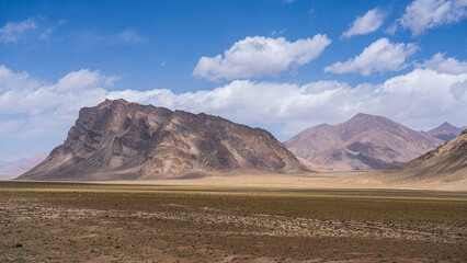 Scenic high altitude desert mountain landscape view along M41 aka Pamir Highway in summer, Murghab, Gorno-Badakhshan, Tajikistan