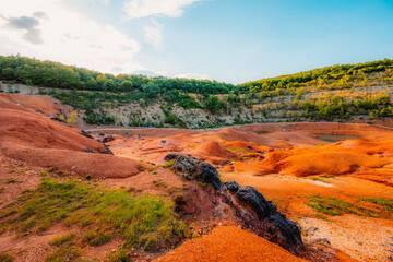 Gant, Hungary, view of the terraces of an old bauxite mine and bauxite formation with red and orange surface. Gánt Bauxitbánya.