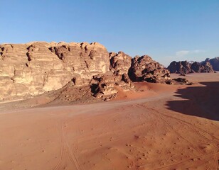 Expansive desert landscape with towering sandstone formations under a clear blue sky