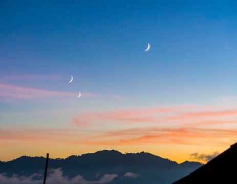 Crescent moons over a mountain range at twilight - Powered by Adobe