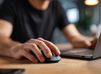 Close-up of person using laptop and mouse