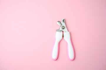 Pet grooming tool on pink background, clipping nails