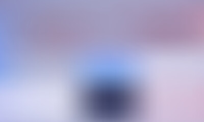 Soft focus of a person in a dark outfit against a pastel background