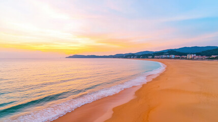 Obraz premium Aerial view reveals vibrant orange and pink sunrise over peaceful sandy beach and expansive ocean coastline, inspiring