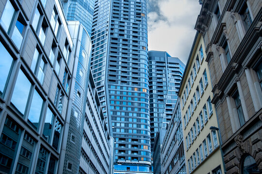 Cluster of Frankfurt high rise towers with glass facades, corporate architecture creating rhythm and density, financial district skyline symbolizing modern economy and urban identity