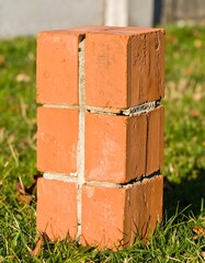 Red brick post in grass