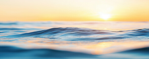 Obraz premium Gentle ripples on calm ocean water reflecting warm sunlight during peaceful sunrise or sunset moment