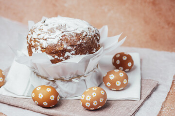 Traditional Easter cake with hand-painted daisy eggs on fabric. Homemade festive baked goods and decor.