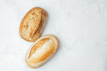 Freshly baked artisan bread loaves on a light background