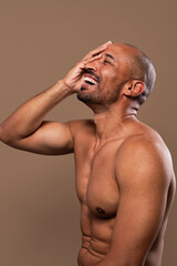 Fototapeta premium Beauty portrait of middle-aged hispanic black handsome man on colored background, concepts about beauty treatment, skincare and cosmetics for men