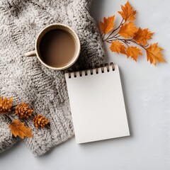 Cozy autumn scene with coffee sweater and notepad