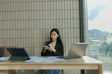 rofessional female employee seriously analyzing data on her computer.