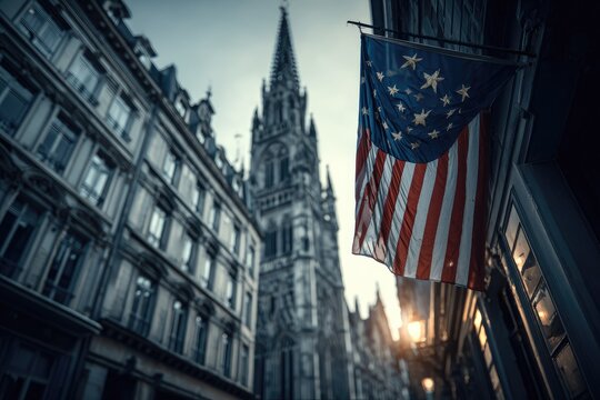 A low-angle view of a historical flag hanging outside a building, with a gothic church in the background - Powered by Adobe