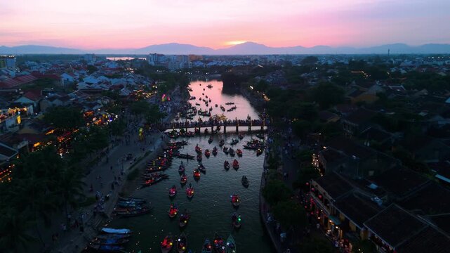 Tourists are enjoying the full moon festival with floating lanterns on thu bon river at sunset in hoi an ancient town, a unesco world heritage site in vietnam