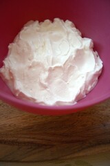 Close-up of sour cream served in a pink bowl with copy space, ideal for culinary or recipe use.
