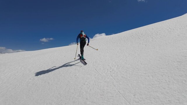 Mountaineering skier climbs alone