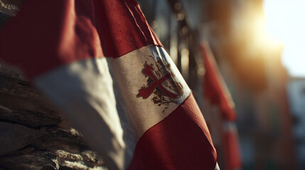 Obraz premium A close up shot of a red and white flag with a cross emblem waving in the bright sunlight