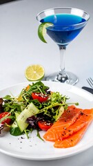 Fresh salmon salad with blue cocktail
