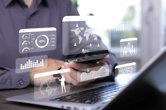 Businessman using smartphone and laptop with futuristic digital data visualization, analytics dashboard, virtual screen interface, big data and global technology concept.