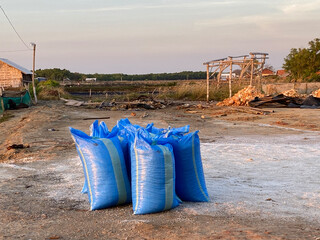 a pile of blue sacks filled with salt ready to be sent to the factory for sale