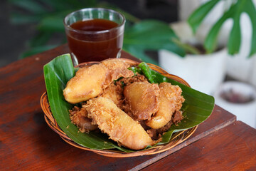Indonesian Fried Banana, captured on September 2, 2025. Traditional snack of ripe banana coated in crispy golden batter, served on rustic plate, authentic homemade flavor