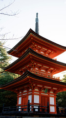 Naklejka premium Majestic three storied pagoda standing tall in japanese garden