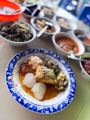 Indonesian traditional food. Indonesian comfort food: Papeda (sago starch) served with turmeric fish stew (Kuah Kuning). A traditional delicacy from Maluku and Papua.