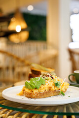 Delicious healthy breakfast plate, sourdough sandwich with scrambled eggs and avocado.
