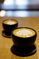 Cup of hot milk latte coffee on table.