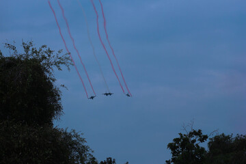 Silhouettes of four fighter planes with smoke in airshow