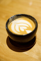 Cup of hot milk latte coffee on table.