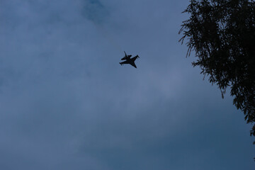 Silhouettes of fighter planes with smoke in airshow