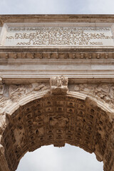 Close-Up of Arch of Titus in Rome Featuring Latin Inscription and Detailed Roman Carvings in Natural Daylight