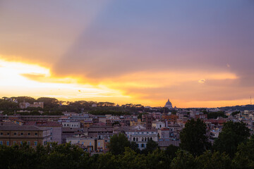 Sunset Skyline Over Rome with View of St. Peter’s Basilica Dome Illuminated Against Colorful Evening Sky