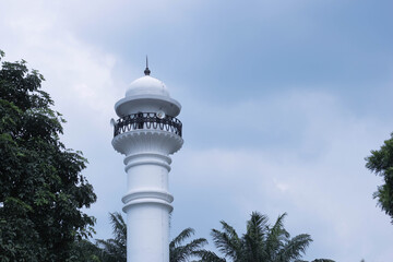 Fototapeta premium mosque tower with blue sky background. Mosque background. Islamic background