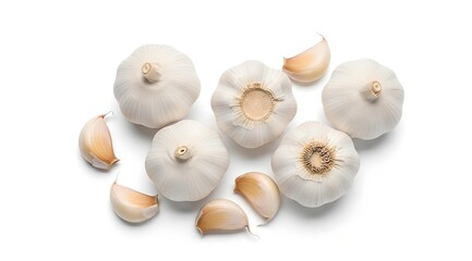 An overhead shot of several whole garlic bulbs and cloves arranged on a plain white surface.