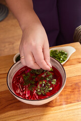 Creating a Beautiful and Colorful Fresh Salad with a Variety of Herbs and Roasted Beets