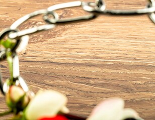 Metal chain frames a wooden surface with flowers