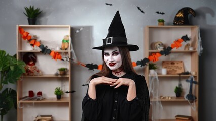 Smiling vampire witch in Halloween costume