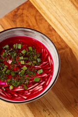 Deliciously Vibrant Beetroot Soup Garnished with Fresh Herbs Served in a Rustic Bowl