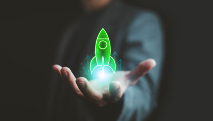 Futuristic green rocket icon hovering above a businessman’s hand, symbolizing startup growth, innovation, technology success, and business launch strategy with modern digital concept.
