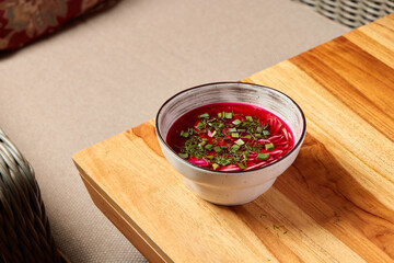 A Delightfully Vibrant Beetroot Soup Skillfully Garnished with Fresh, Flavorful Herbs