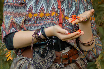 Young woman dressed in boho style in autumn park with rowan berries in hands © Светлана 