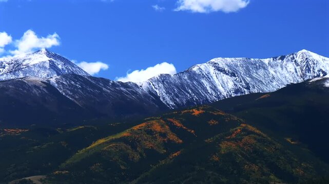 Mt Mount Shavano 14er Tabeguache Peak aerial drone down motion Colorado trail Sawatch Range fall autumn aspen trees San Isabel National Forest snow dusting morning vibrant blue sky clouds